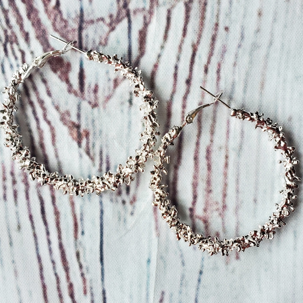 Silver hoop ear rings molten rock design